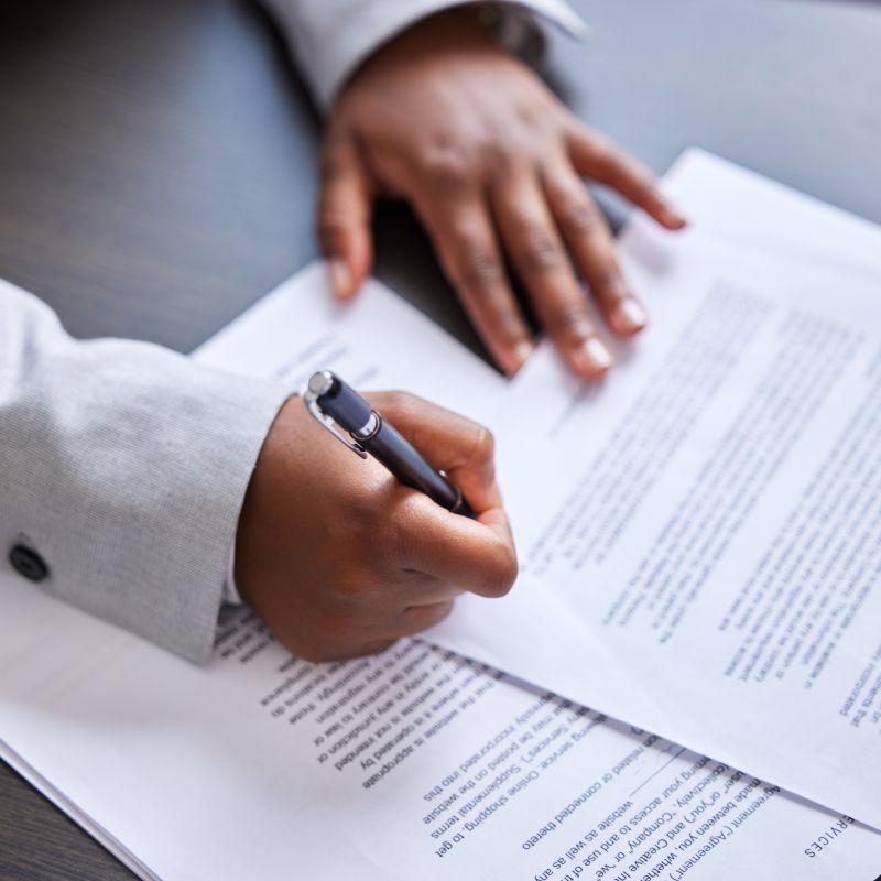 Professional signing Social Security death master file compliance paperwork.